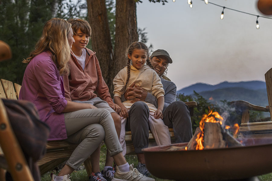 a family by a fire pit in evening