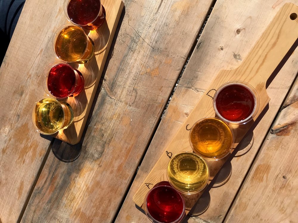two flights of cider on a wooden table