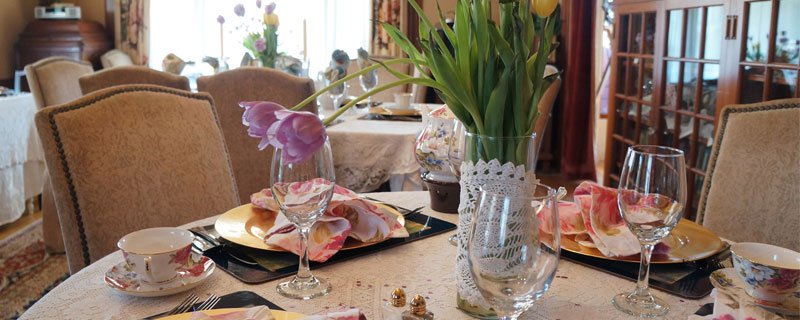 Elegantly set table with spring flowers and tea cups