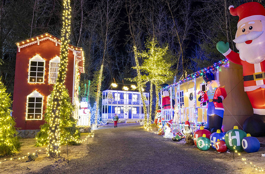 a village of holiday lights and decorations lit up at night