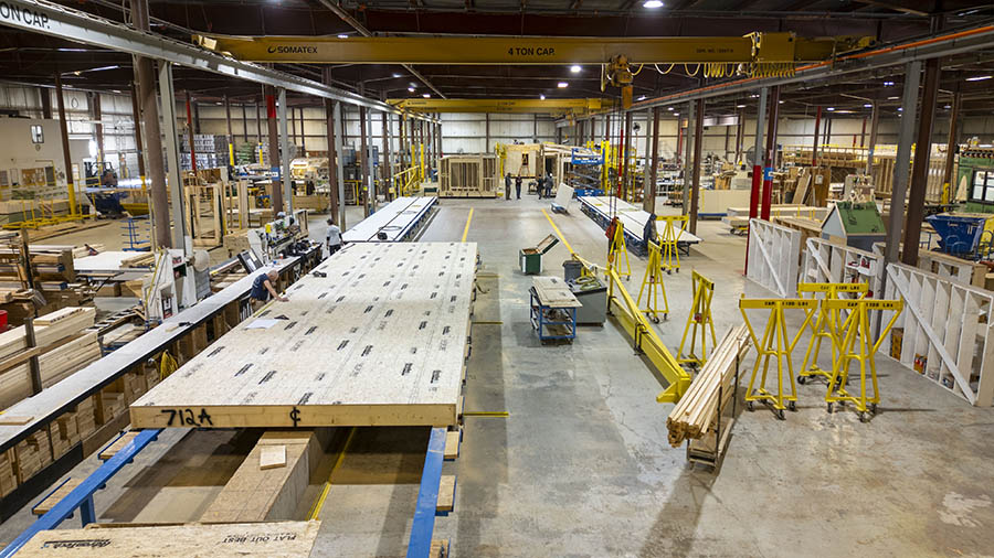 a view of a factory floor with boards and lifts