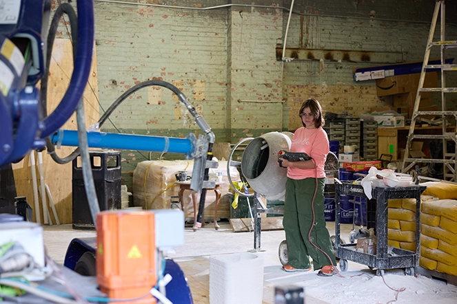 A woman operating a machine in a warehouse