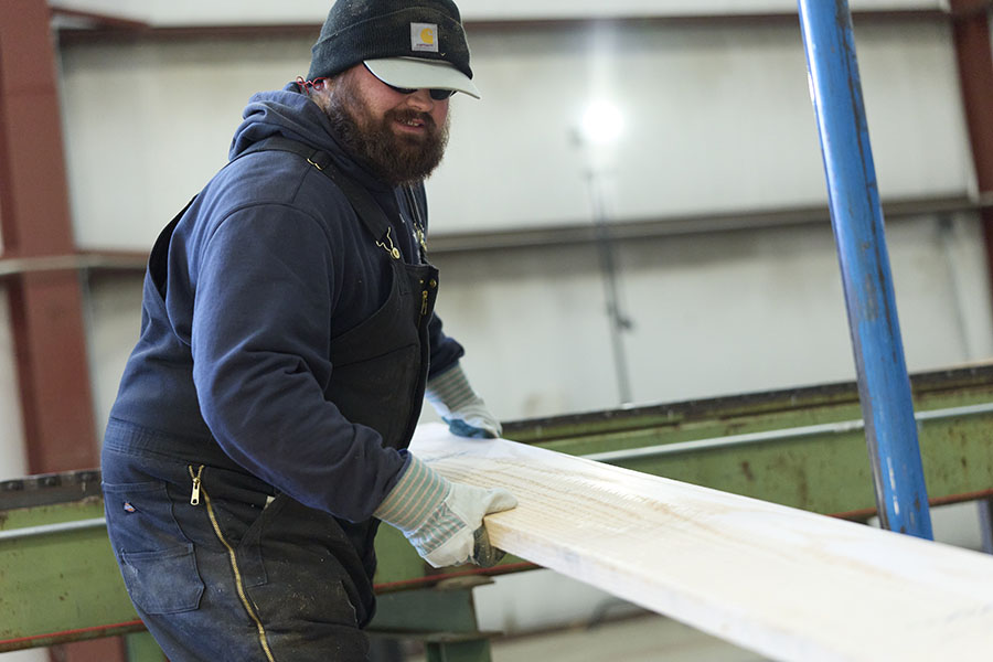 Northland Forest Employee moving a board inside a warehouse