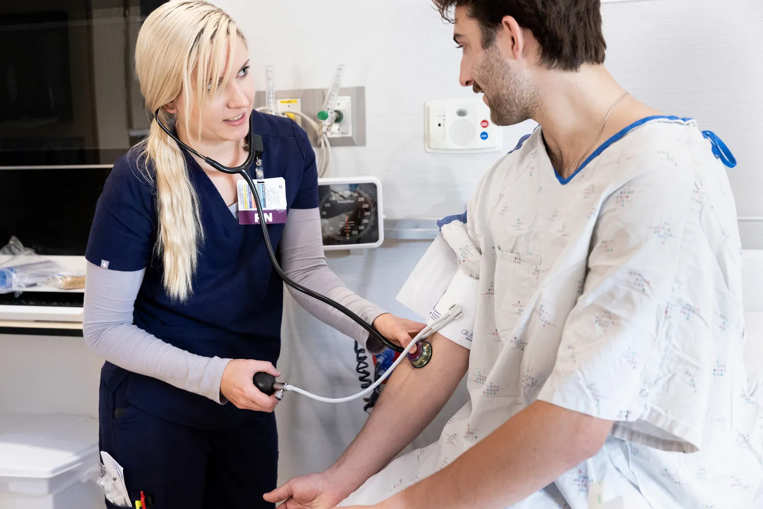 A nurse checking a patients blood pressure