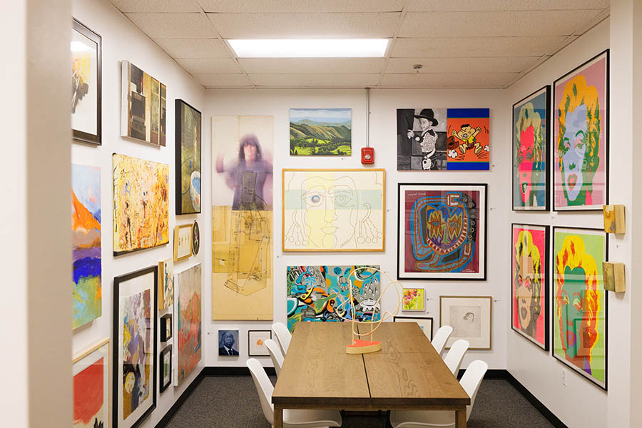 an art gallery with a table in the middle of the room