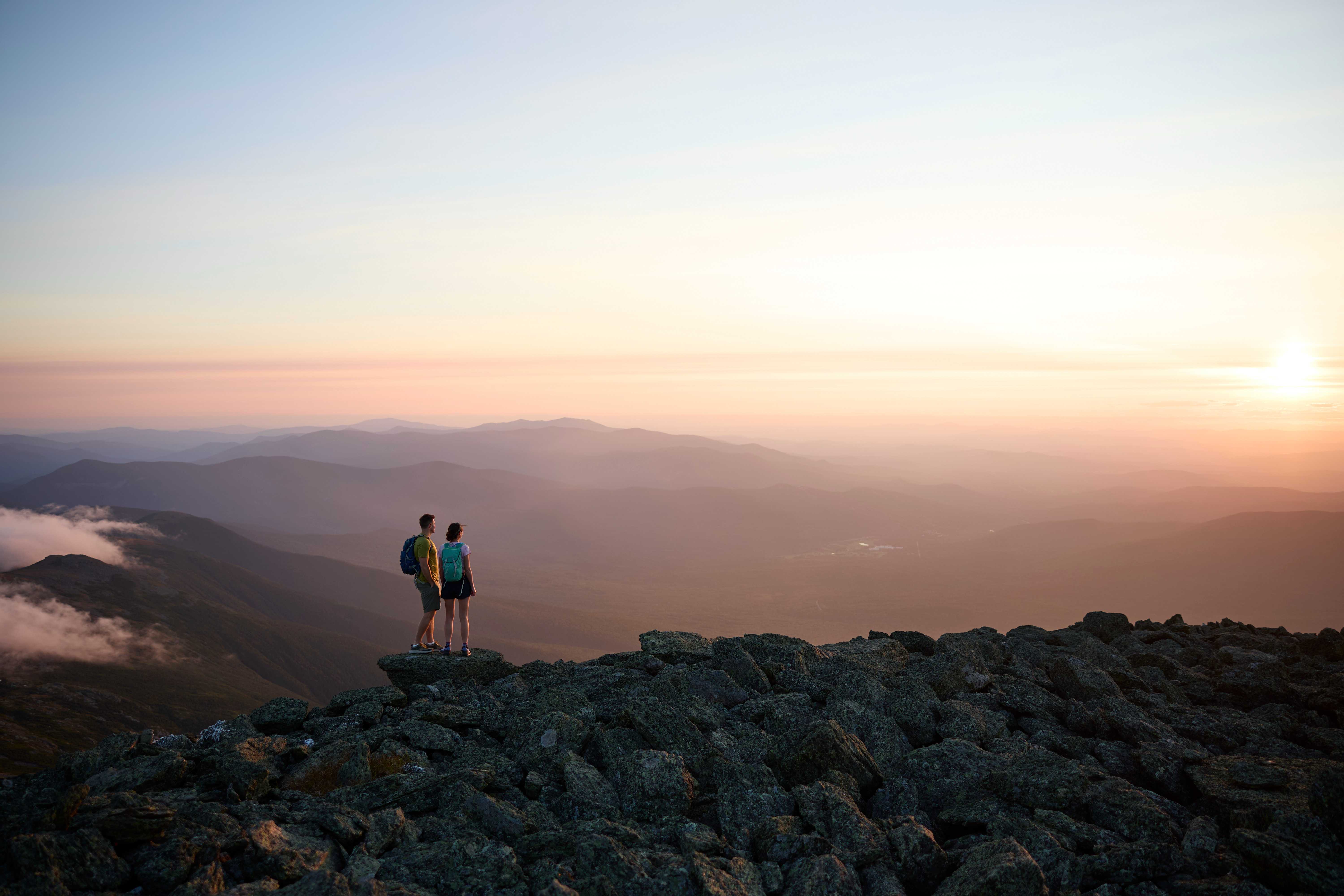 Two people on Mountain top watching sun set