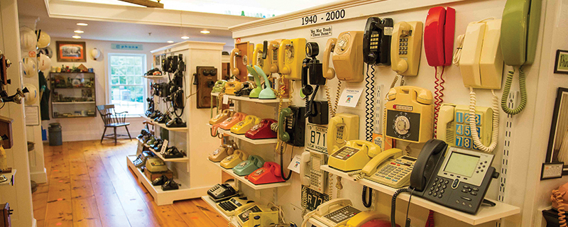 shelves in a museum full of telephones