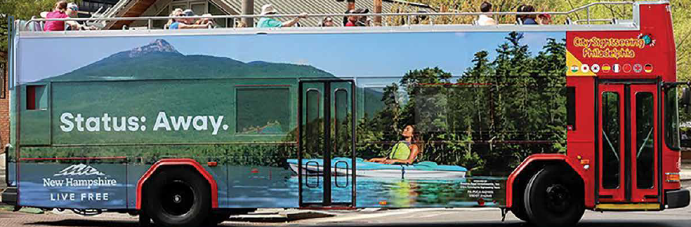 VisitNH Bus wrap with kayaker and mountain in background