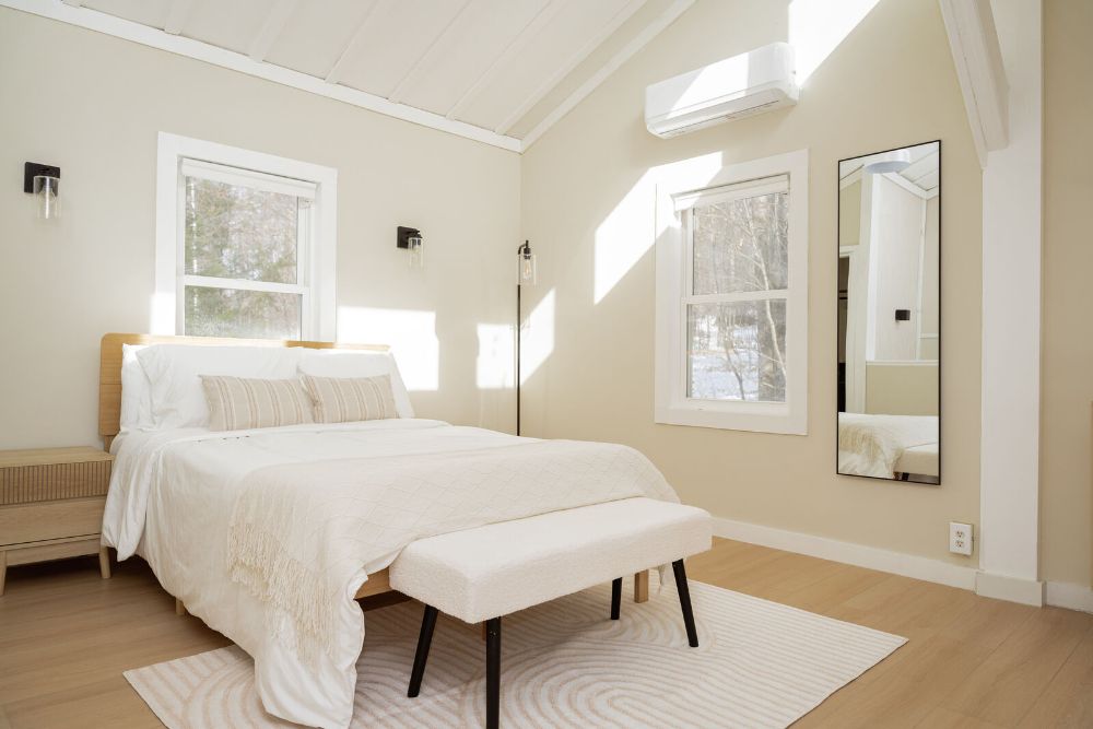 Sunlit bedroom with woodland views