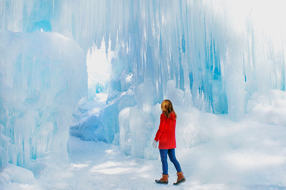 woman standing at ice castles